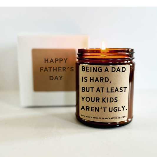 funny personalized candle for day with a message that says being a dad is hard but at least your kids aren't ugly