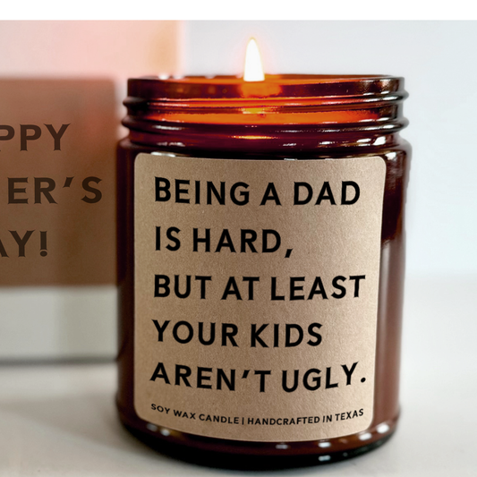 funny personalized candle for day with a message that says being a dad is hard but at least your kids aren't ugly
